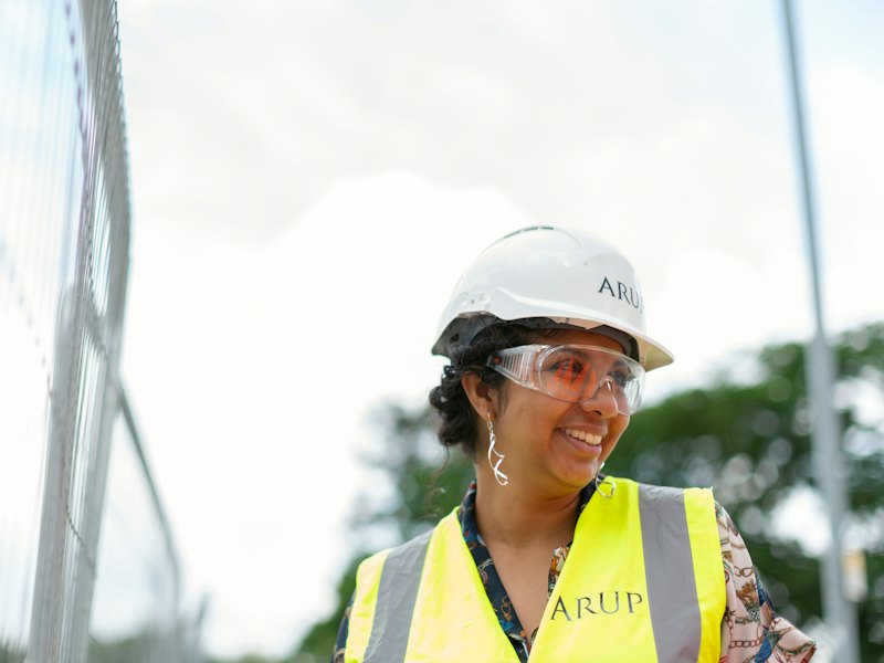 An engineer in a hard hat and safety vest on site